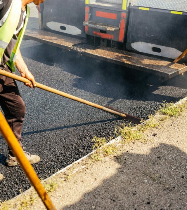 road-construction-crew-used-shovels-scatter-more-asphalt-top-new-pavement